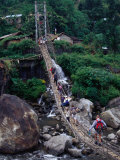 People Crossing Sagging Suspension Bridge Over Khudi Khola on Annapurna Circuit, Nepal