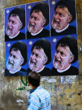 Passerby Looking at Political Posters on Wall, Tyre, Lebanon
