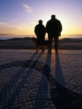 Buy Two Men Watching Sunset Over Beach, Nazare, Portugal at AllPosters.com