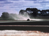 Buy Tractor Ploughing a Field and Dust at AllPosters.com