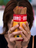Woman Holding Prayer Sticks at Wong Tai Sin Temple, Kowloon, China