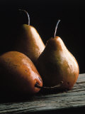 Detailed Image of Three Pears on Wood Surface
