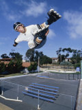 Teenage Boy Jumping in Mid Air Wearing Inline Skates