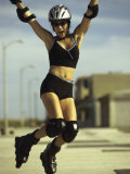 Portrait of a Young Woman Jumping While Wearing Inline Skates