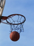 Low Angle View of a Basketball Going Through the Hoop