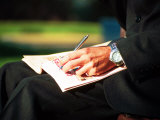 Businessman Writing on Newspaper