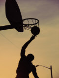 Silhouette of a Young Man Playing Basketball