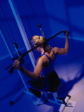 Rear View of a Young Woman Exercising in a Health Club