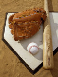 Baseball Bat with a Glove, and a Baseball on the Home Base