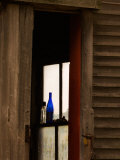 Old Blue Bottle in Window of Barn in Rural New England, Maine, USA