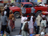 An Water Vendor Walks in the Streets of Port-Au-Prince, Haiti
