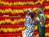 Villagers Walk Past Freshly Dyed Kalawa, a Sacred Orange-Yellow Thread Used in Hindu Rituals