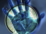 Abstract View of a Blue Hand over a Stop Watch