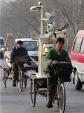 Two Delivery Riders Carry a Dentists Drill and Chair Along a Beijing Street January 4