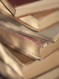 Stack of Worn Hardcover Books with Yellowed Pages