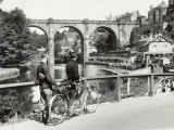 Buy Two Cyclists Take a Break on a Bridge Over the River Nidd at Knaresborough at AllPosters.com