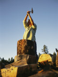 A Woman Chops Wood with an Axe
