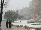 Two Priests Walk in Snow in Front of the Jaffa Gate in Jerusalem's Old City, December 27, 2006