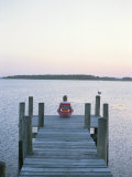 A Seagull Watches a Woman Practice Yoga on a Dock