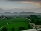 Buy An Afghan Man Rides His Bicycle on a Dirt Road on the Northern Edge of Kabul, Afghanistan at AllPosters.com