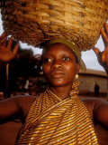 Buy Woman Wearing Gold Fabric Dress and Carrying Basket, Kabile, Brong-Ahafo Region, Ghana at AllPosters.com