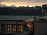 Buy A Worker Cuts a Piece off a Roof That was Torn Away During a Storm in Prague, January 19, 2007 at AllPosters.com