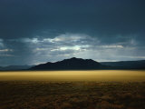 The Setting Sun Permeates Rain Clouds to Brighten Black Rock Desert, Nevada