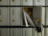 Letters and Bills are Sticking Out of a Post Office Box
