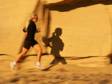 A Woman Jogs on a Mountain Path