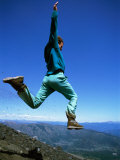 Buy A Hiker Takes a Giant Leap Atop a Mountain in Chile at AllPosters.com