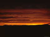 The Deep-Orange Light of Sunset Illuminates Heavy Clouds