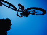 A Mountain Biker Careens in the Air and the Photographer Captures This Dynamic Image from Beneath