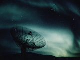 A Satellite Dish Silhouetted against the Northern Lights