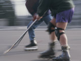 Two Men Battle for the Puck During a Roller-Hockey Game