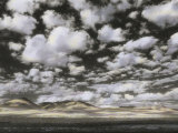 Buy Puffy Clouds Fill a Sky Above Gentle Rolling Hills in the Distance at AllPosters.com