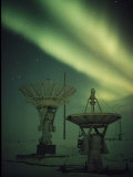 Antennas Point Skyward under the Glowing Aurora Borealis