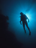 A Scuba Diver Silhouetted by the Sun
