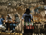 Filtered Sunlight Casts Shadows on Cafe Patrons and Staff