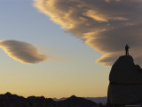 A Climber Atop a Rock Formation at Sunset