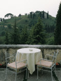 Cafe Table and Chairs Overlooking a Villa on a Hill