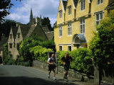 Hikers Jog Along a Street in the Village of Castle Coombe