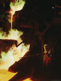 A Man in Protective Gear Tends a Smelter at Magma Metals Company