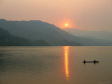 Buy Setting Sun Reflected in Lake Phewa with Boat and Mountains at AllPosters.com
