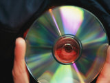Buy An Eye is Seen Looking Through the Hole of a Compact Disc at AllPosters.com