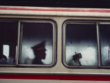 Buy A Chinese Pla Soldier Sits on a Bus Behind a Tibetan Prayer Wheel at AllPosters.com