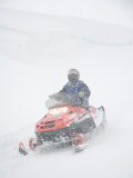 Buy A Woman Drives Along on a Snowmobile in a Blizzard at AllPosters.com