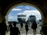 People Walking Through Port Entrance to Two Cruise Ships