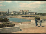 Two Women Look Across Captial Park and its Reflecting Pool Toward Union Station
