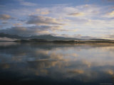 Buy Clouds and Shoreline Reflected in Tranquil Waters at Sunset at AllPosters.com