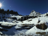 A White-Tailed Ptarmigan Blends into a Landscape of Rock and Snow